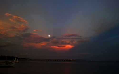 cloud shaped like a dragon watches the fullmoon rising